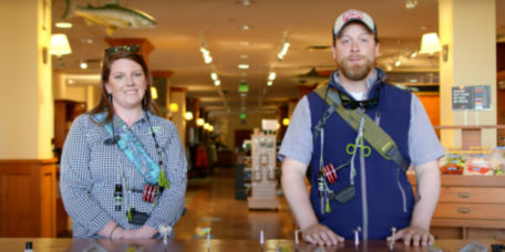 Two people in an Orvis Store geared up to teach a virtual class