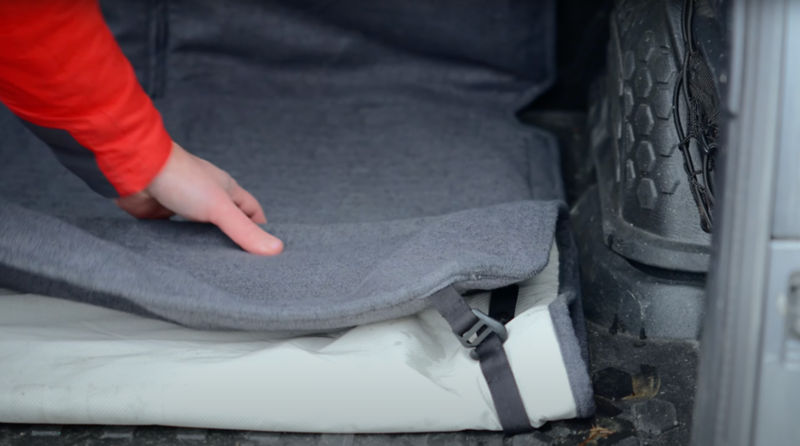 A man showing how to install the Orvis Grip-Tight&reg; Cargo Protector.