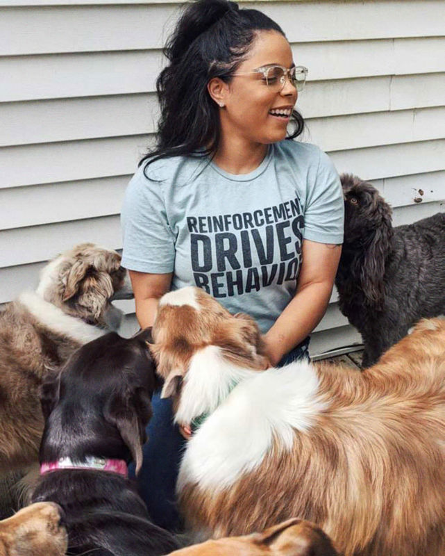 Melinda is happliy surrounded by four dogs she's pet-sitting.