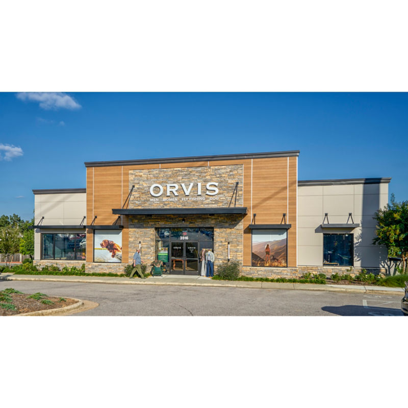 An Orvis storefront in Raleigh, NC under a bright blue sky.