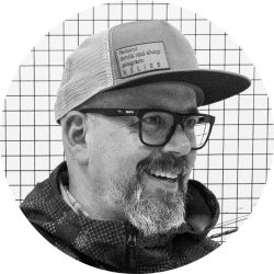 A black and white headshot of Fly Rod Designer, Shawn Combs.