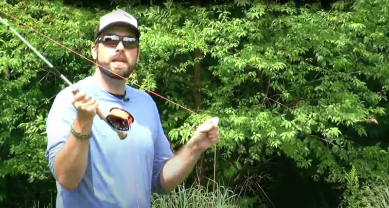 Close-up of an instructor holding a fly rod